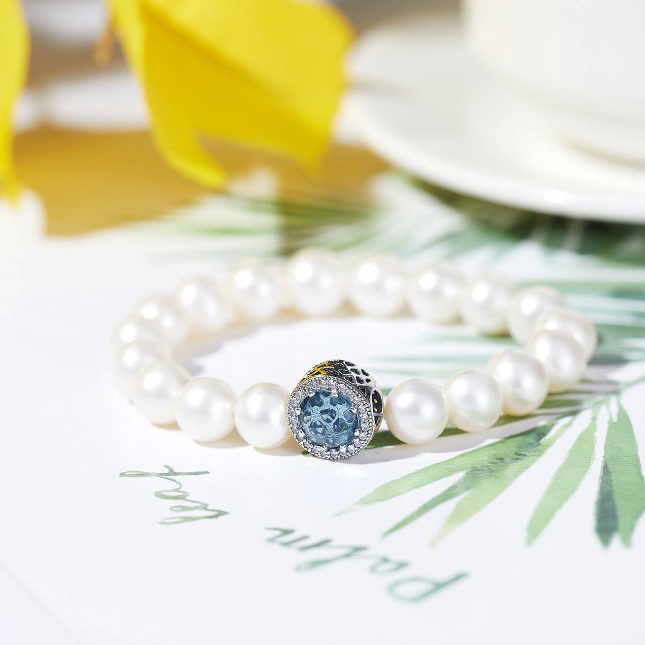 Elegant Freshwater Pearl Bracelet WB00039 featuring white pearls and sapphire blue cubic zirconia, set in gold-plated sterling silver.