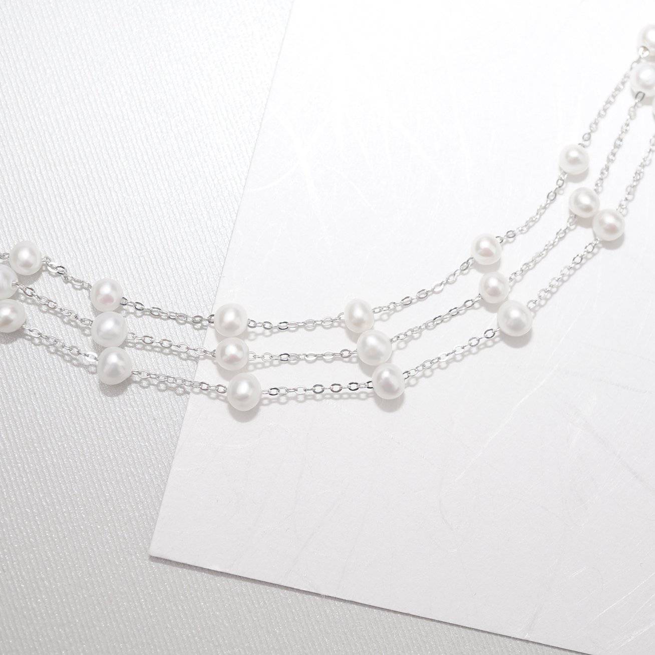 Elegant Freshwater Pearl Bracelet WB00048 featuring scattered white pearls on a sterling silver and gold plated base, showcasing a delicate and dreamy design.