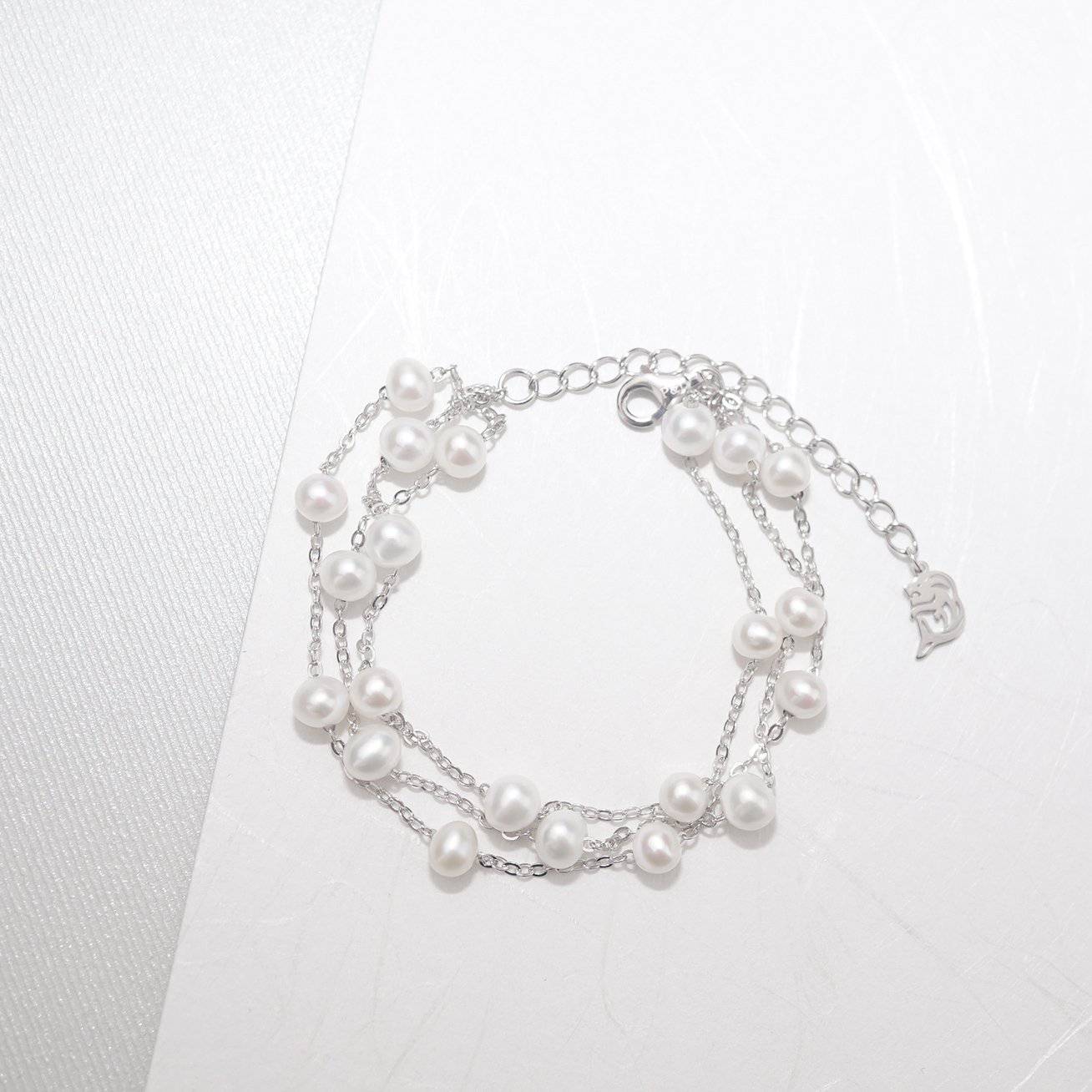 Elegant Freshwater Pearl Bracelet WB00048 featuring scattered white pearls on a sterling silver and gold plated base, showcasing a delicate and dreamy design.