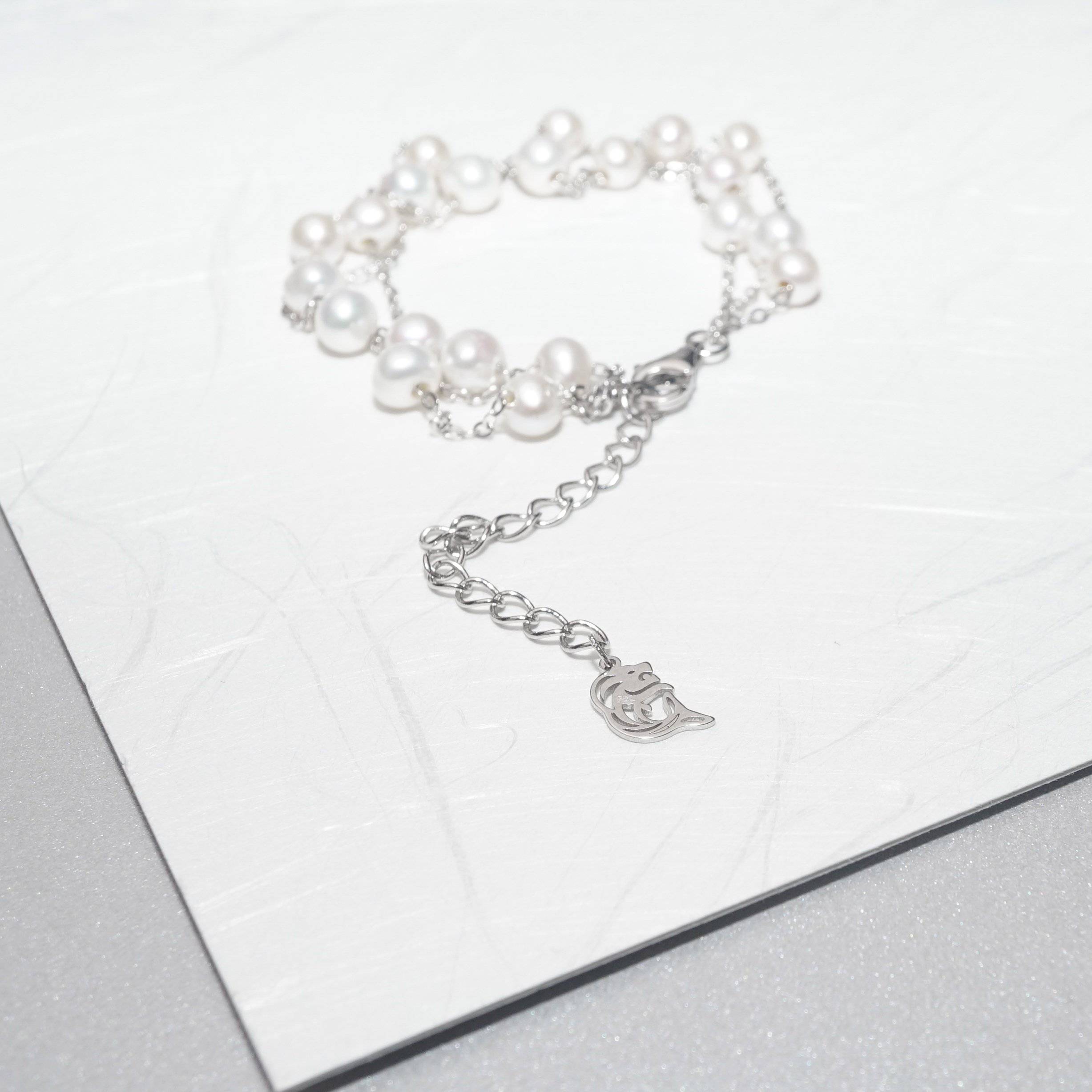 Elegant Freshwater Pearl Bracelet WB00048 featuring scattered white pearls on a sterling silver and gold plated base, showcasing a delicate and dreamy design.