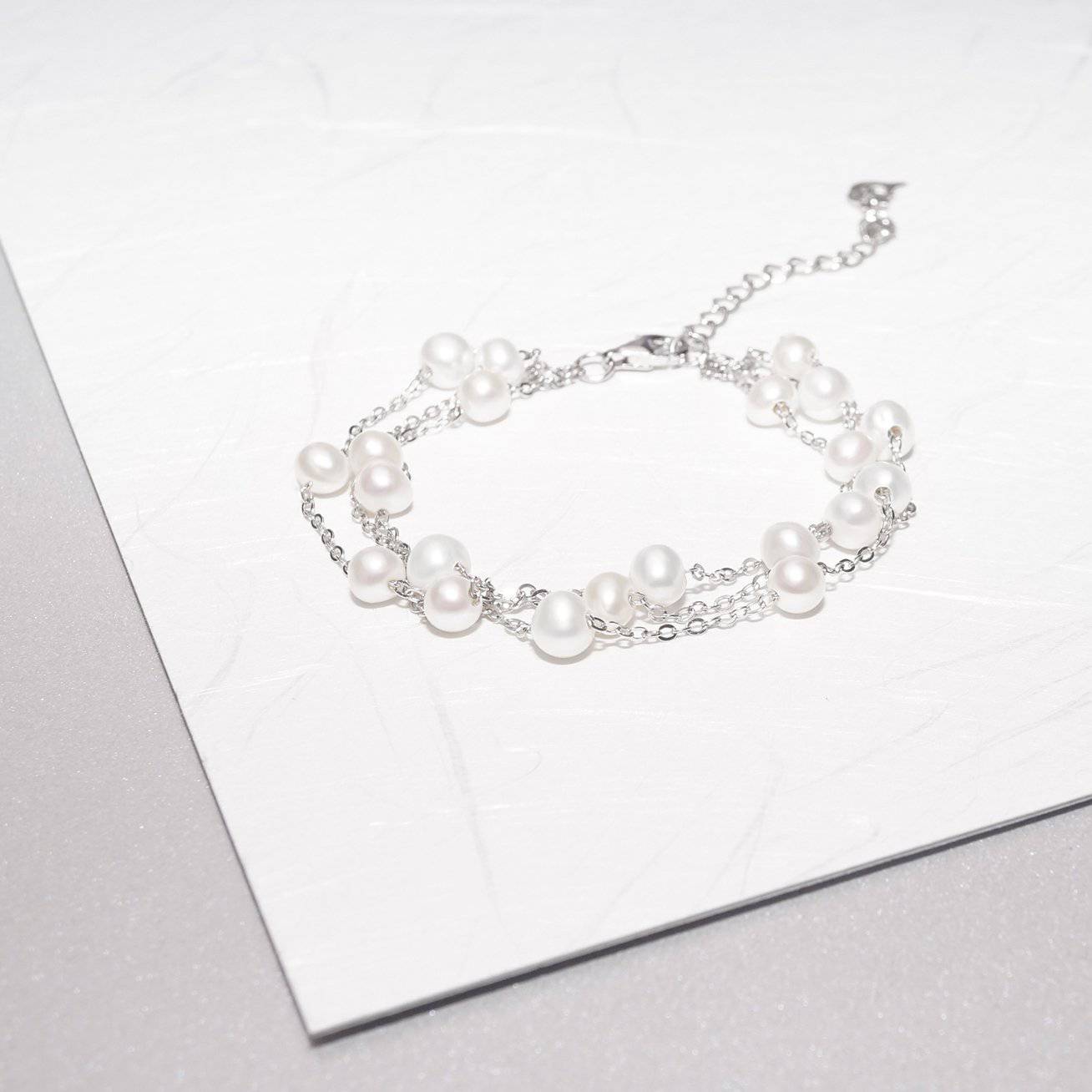 Elegant Freshwater Pearl Bracelet WB00048 featuring scattered white pearls on a sterling silver and gold plated base, showcasing a delicate and dreamy design.