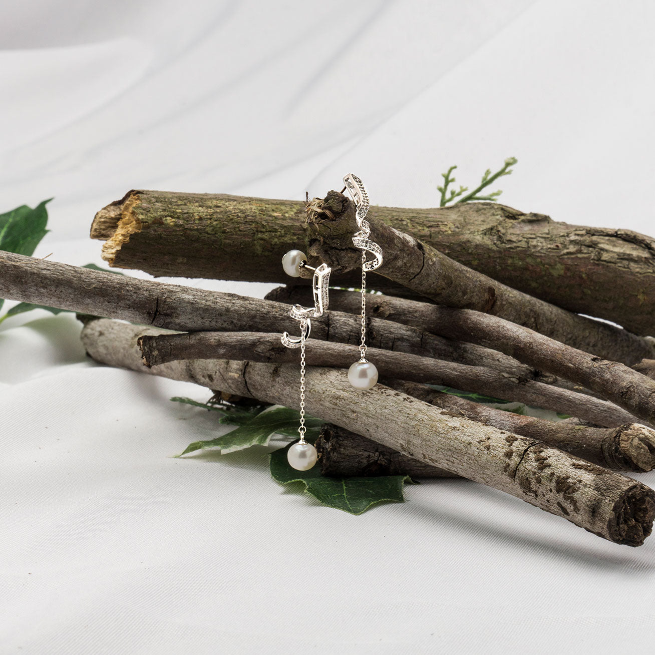 Elegant Freshwater Pearl Earrings featuring a single pearl drop and delicate ribbon design, crafted from sterling silver and gold plated.