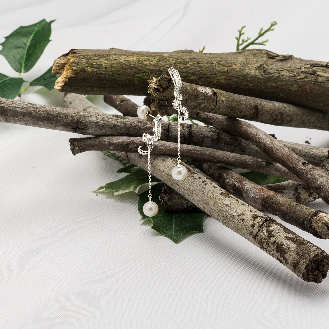 Elegant Freshwater Pearl Earrings featuring a single pearl drop and delicate ribbon design, crafted from sterling silver and gold plated.