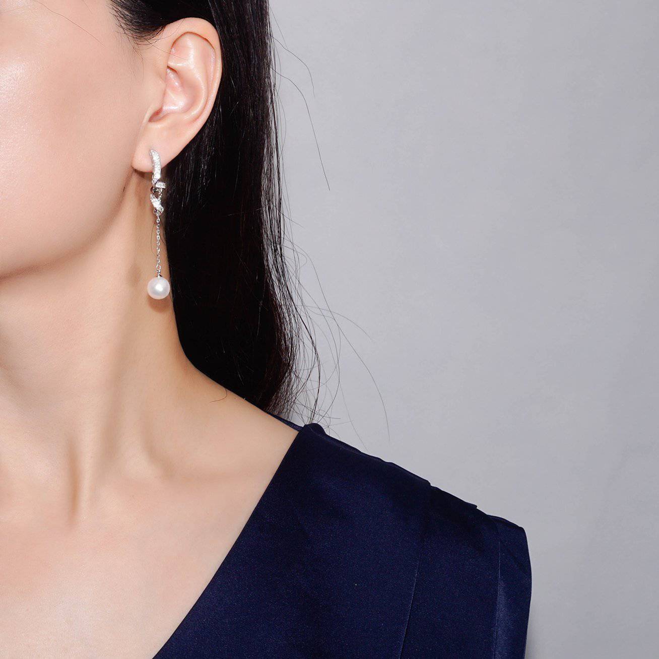 Elegant Freshwater Pearl Earrings featuring a single pearl drop and delicate ribbon design, crafted from sterling silver and gold plated.