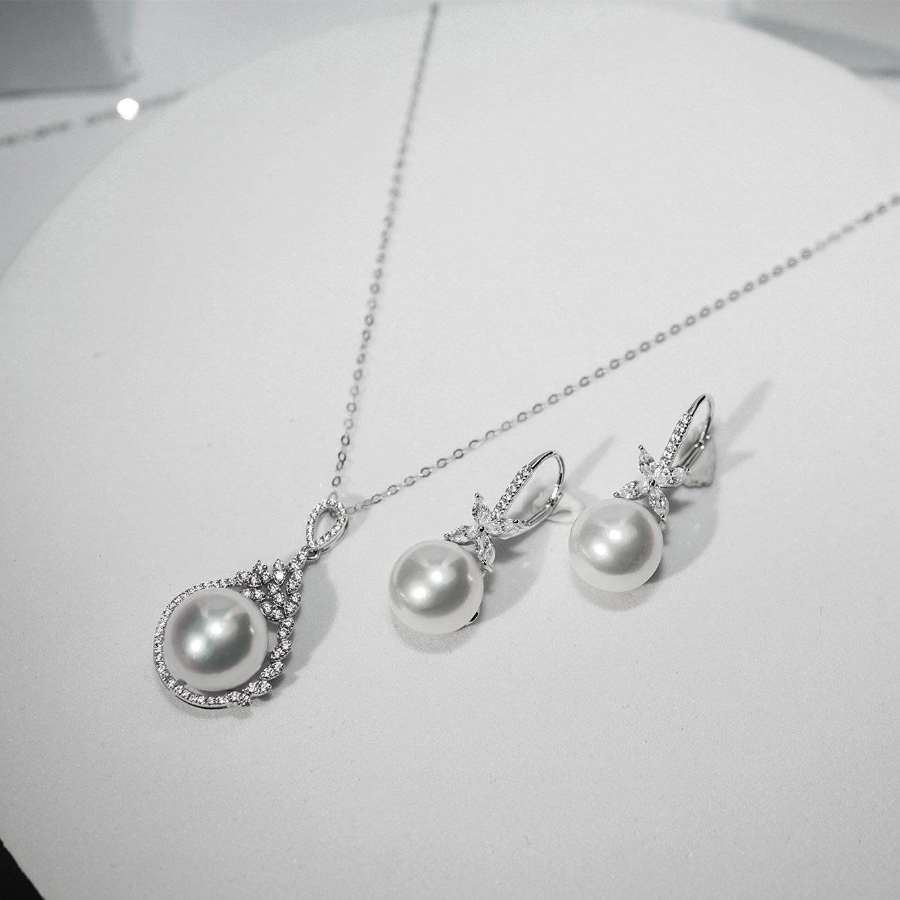 Elegant Freshwater Pearl Earrings featuring 8.5-9.5mm white pearls set in sterling silver with gold plating.