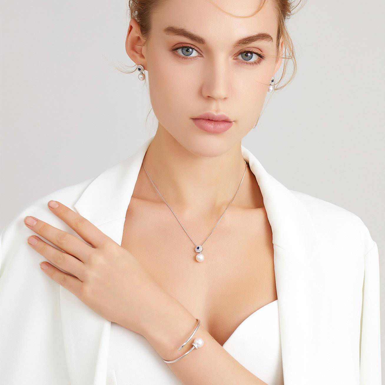 Elegant Freshwater Pearl Earrings with sapphire blue cubic zirconia, showcasing round white pearls and sterling silver with gold plating.