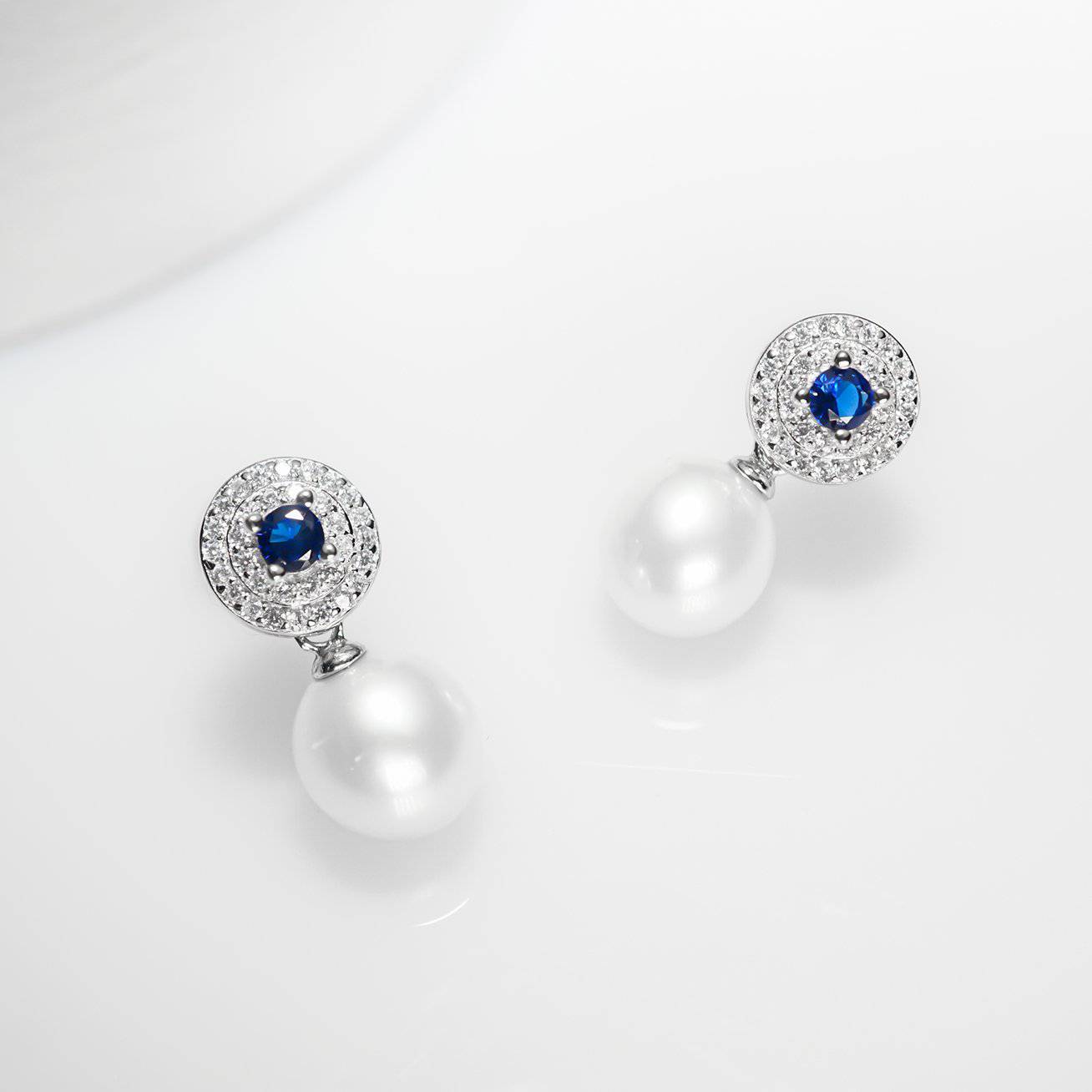 Elegant Freshwater Pearl Earrings with sapphire blue cubic zirconia, showcasing round white pearls and sterling silver with gold plating.
