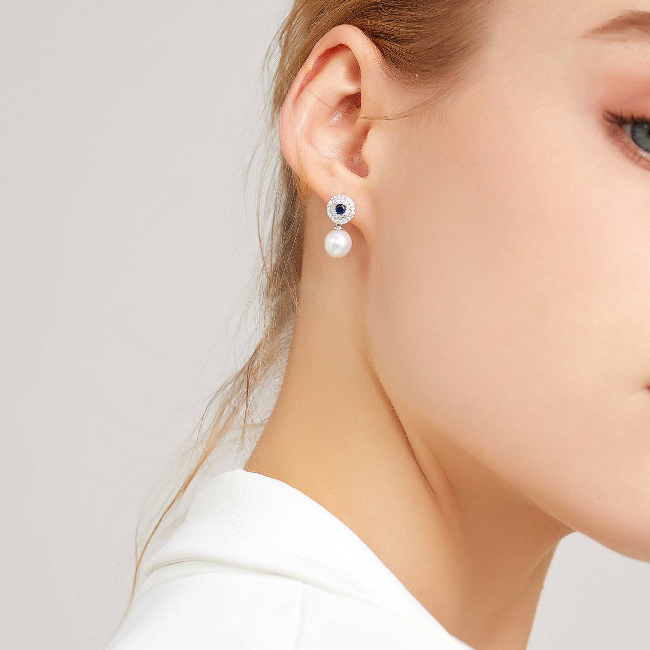 Elegant Freshwater Pearl Earrings with sapphire blue cubic zirconia, showcasing round white pearls and sterling silver with gold plating.