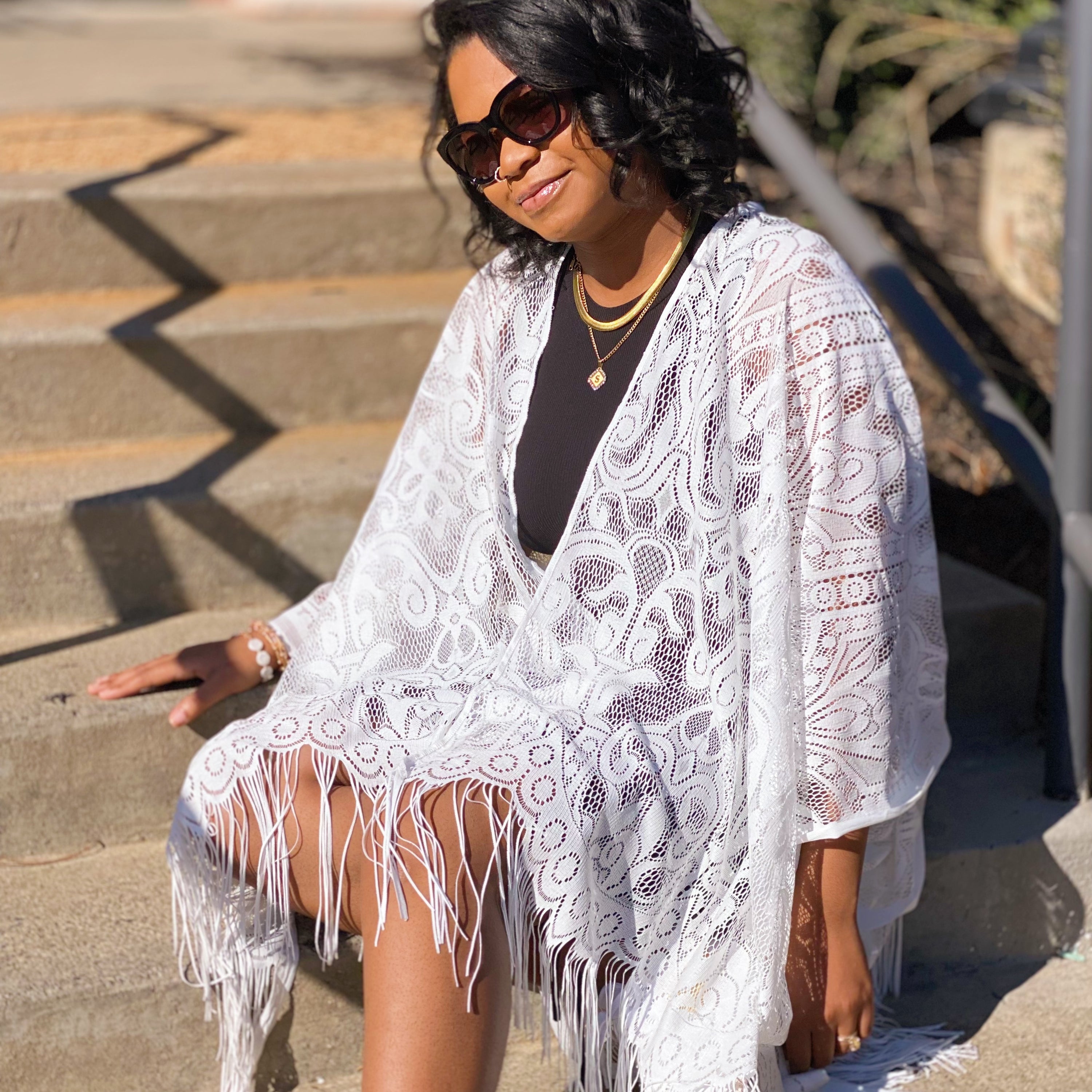 Elegant lace kimono with fringes, showcasing intricate lace patterns and laser-cut edges, perfect for layering over outfits.