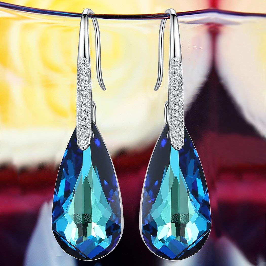 Elegant Elements Bermuda Blue Drop Earring in 14K White Gold Plating featuring a teardrop design and fish hook clasp.