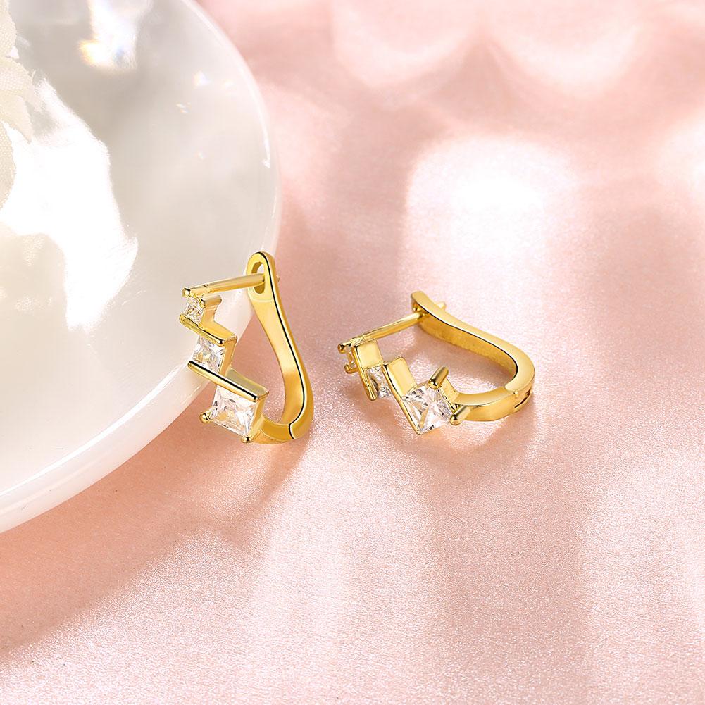 Elegant Elements Intertwined Clip On Earrings featuring certified crystals and 18K gold plating, designed for comfort and style.
