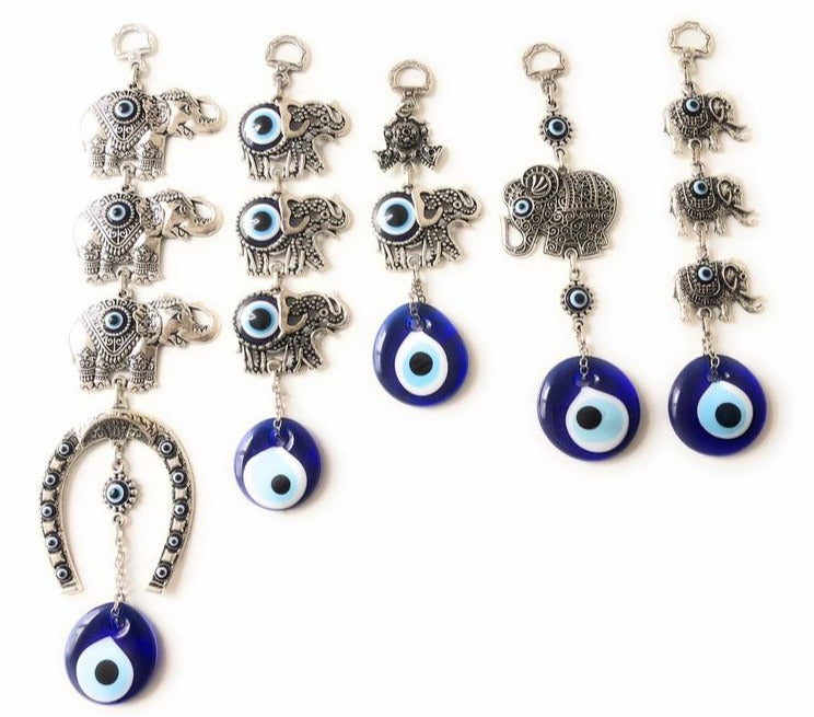 Beautiful elephant wall art featuring good luck beads, crafted from metal with vibrant evil eyes.