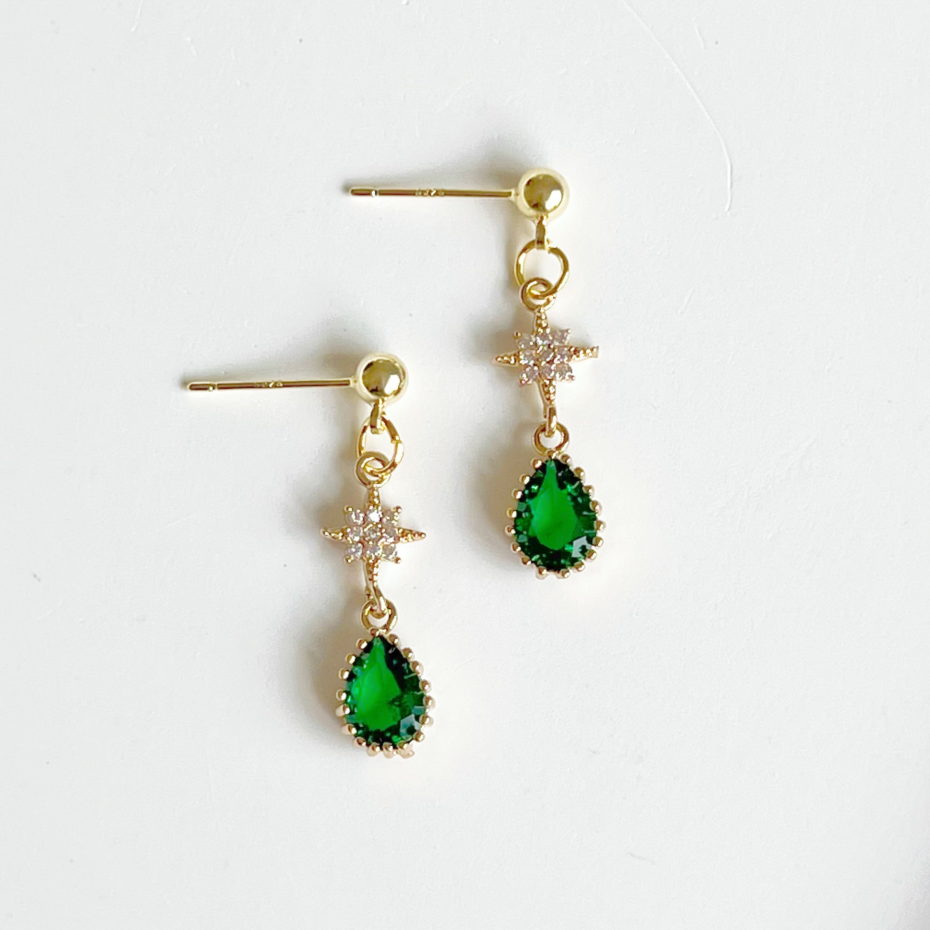 Emerald Green and Star Drop Earrings featuring gold-plated bronze, emerald green glass crystals, and freshwater pearl accents.