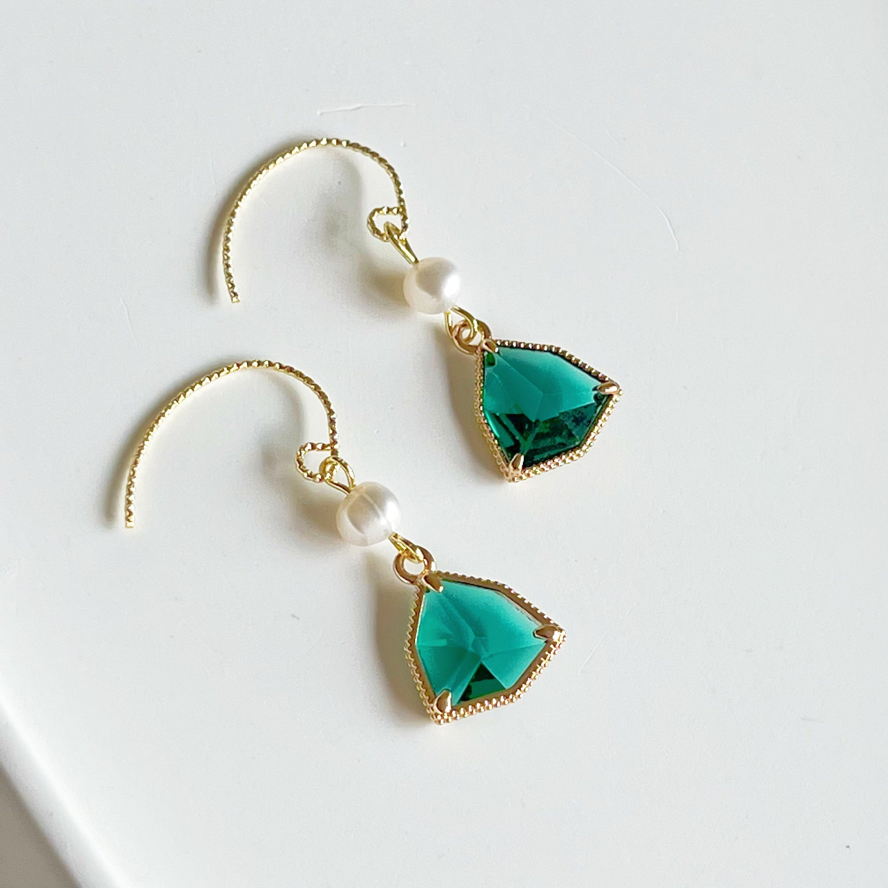 Emerald green crystal and pearl drop earrings featuring gold-plated bronze ear wires and freshwater pearls.