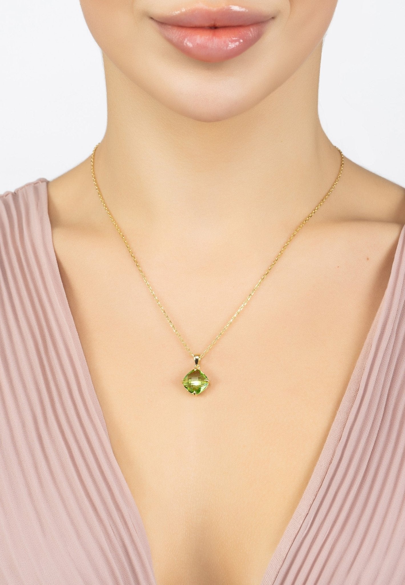 Empress Gemstone Necklace featuring a gold-dipped chain and a vibrant Peridot gemstone, elegantly displayed.