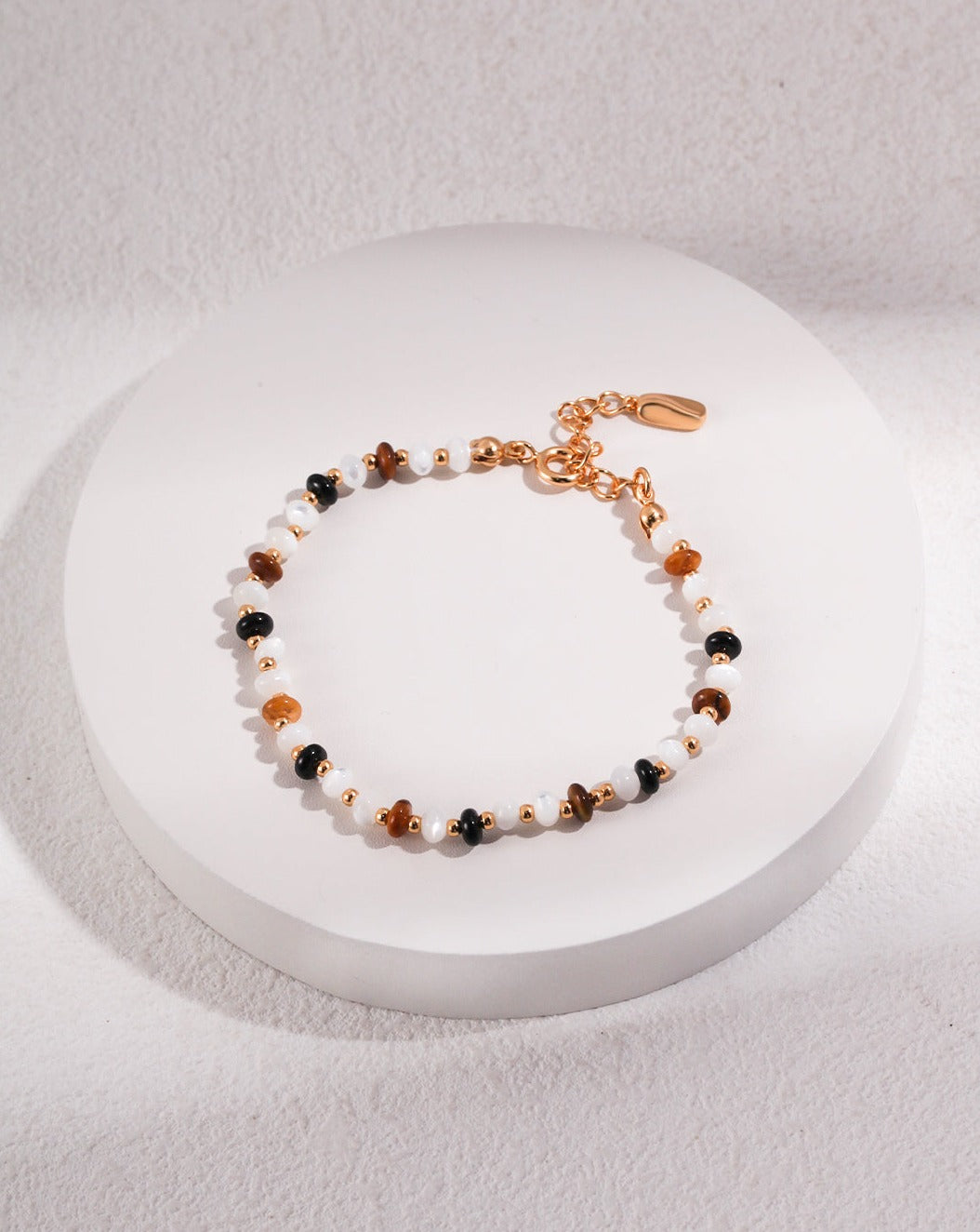 Energetic Amber Tiger's Gaze Pearl Bracelet featuring freshwater pearls and tiger's eye gemstones, showcasing elegance and strength.