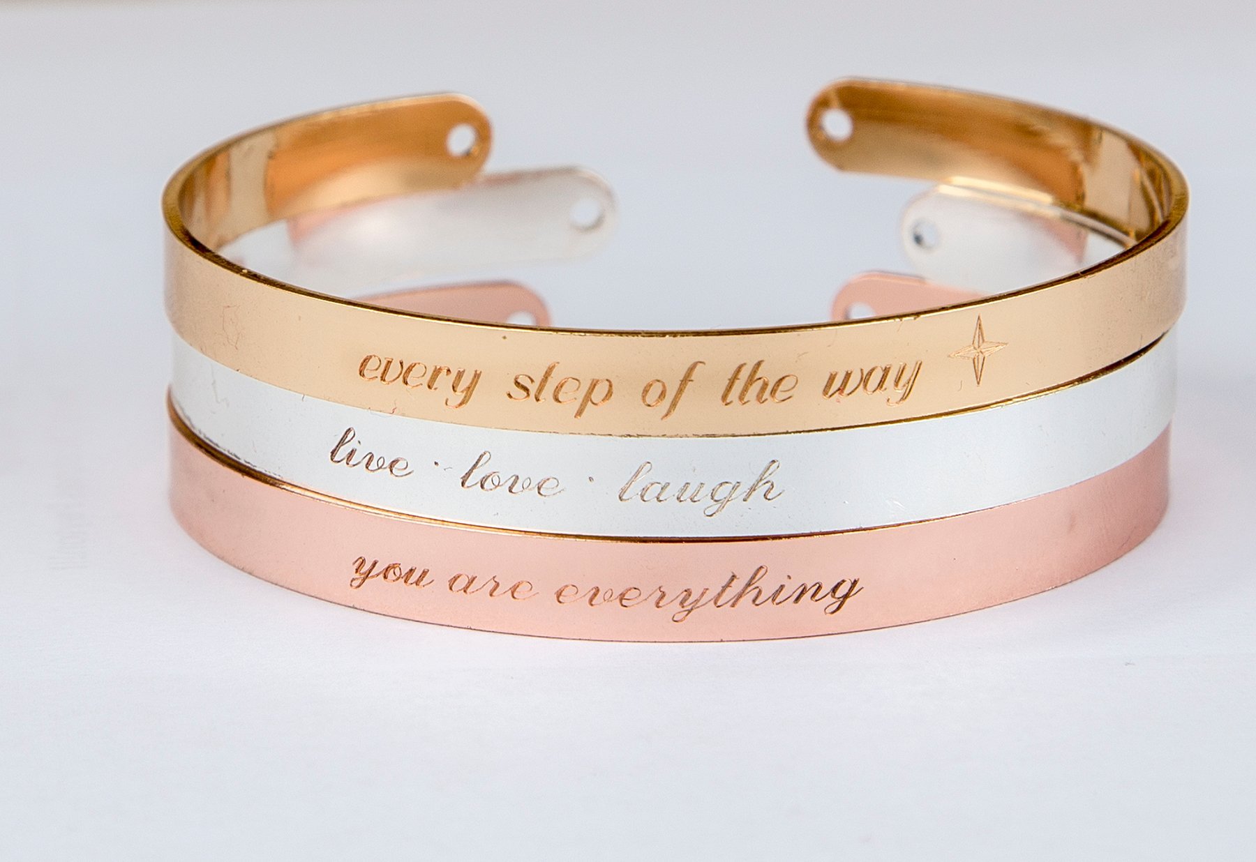 A delicate engraved bracelet in rose gold, featuring an inspirational quote, adjustable design, and protective lacquer finish.