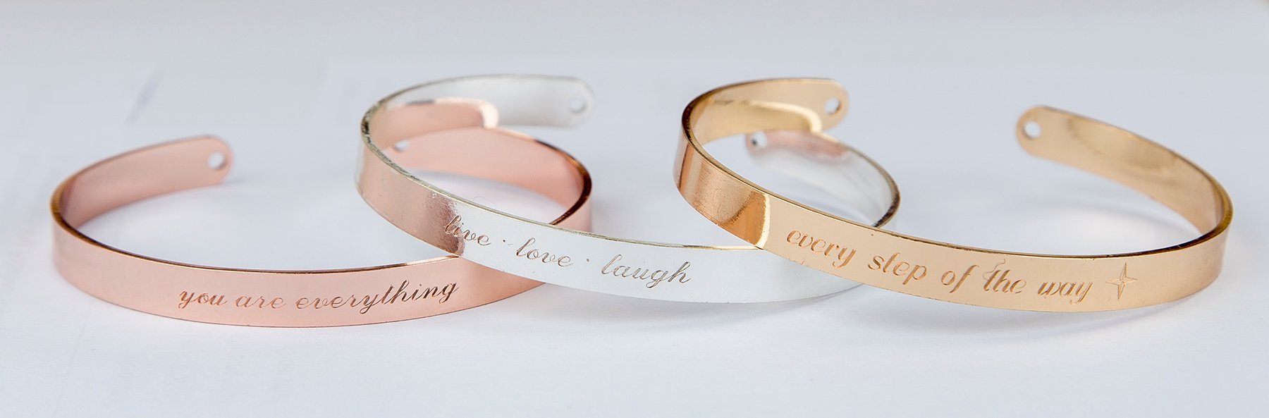 A delicate engraved bracelet in rose gold, featuring an inspirational quote, adjustable design, and protective lacquer finish.