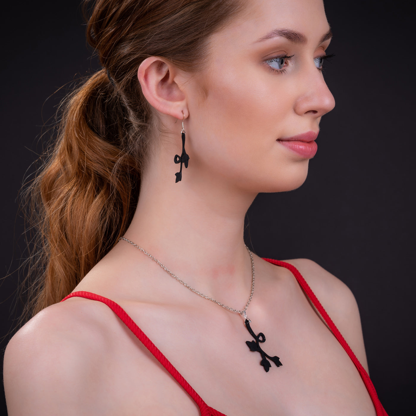 Evelyn Floral Pendant Necklace made from recycled tyre inner tubes, featuring a delicate floral design on a stainless steel chain.