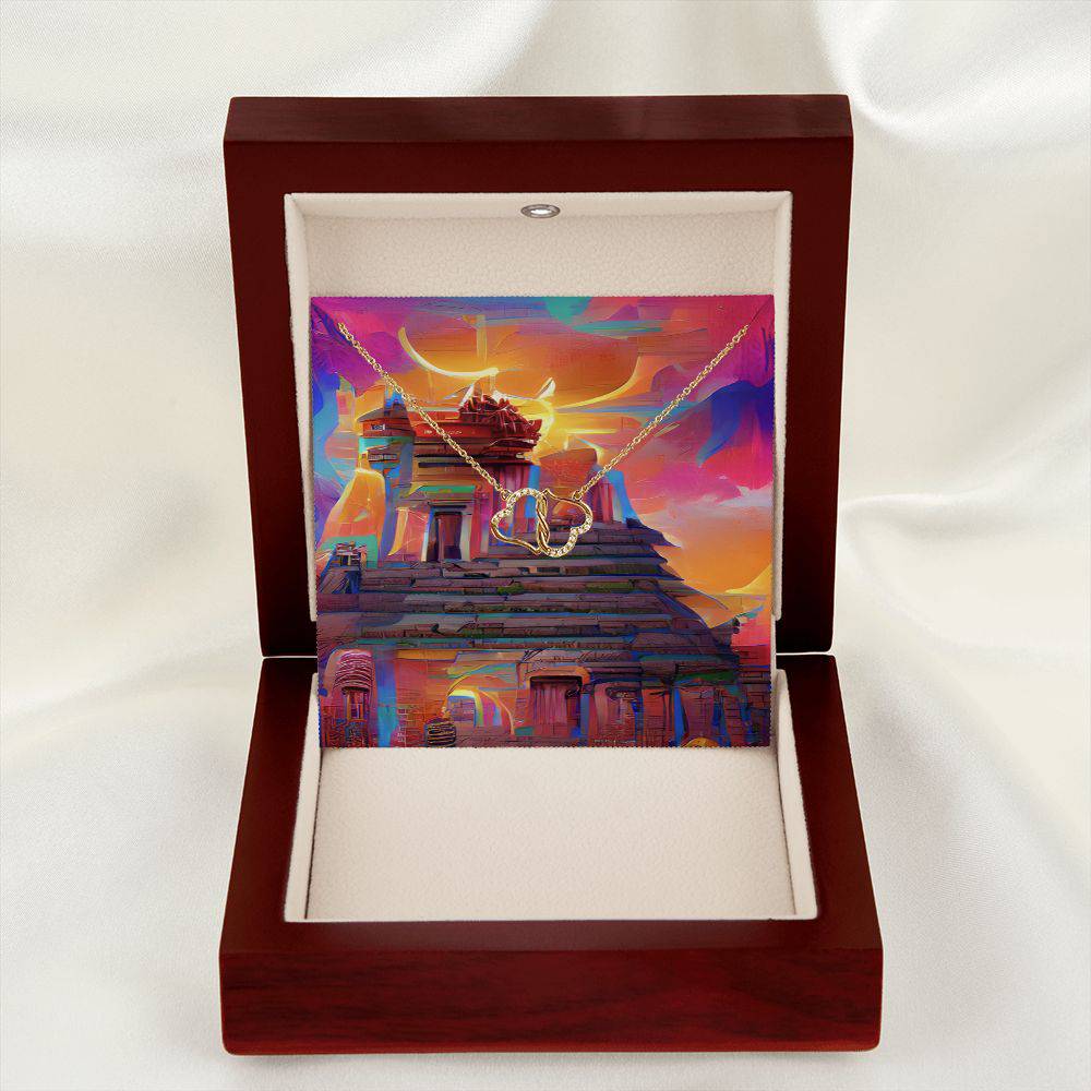 Everlasting Heart necklace featuring two interconnected 10K solid yellow gold hearts adorned with 18 pave set diamonds, displayed in a luxurious mahogany gift box.