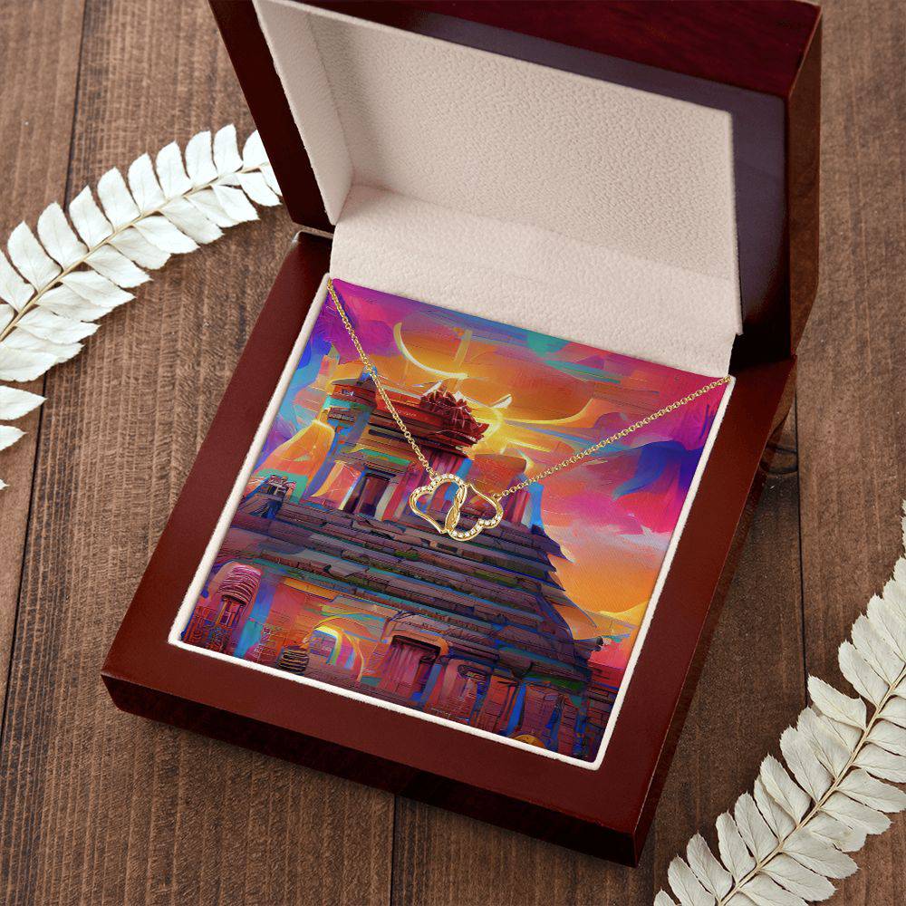 Everlasting Heart necklace featuring two interconnected 10K solid yellow gold hearts adorned with 18 pave set diamonds, displayed in a luxurious mahogany gift box.