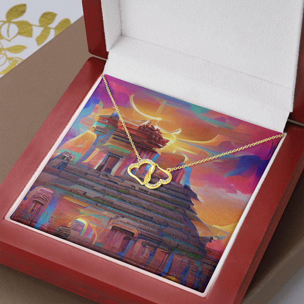 Everlasting Heart necklace featuring two interconnected 10K solid yellow gold hearts adorned with 18 pave set diamonds, displayed in a luxurious mahogany gift box.