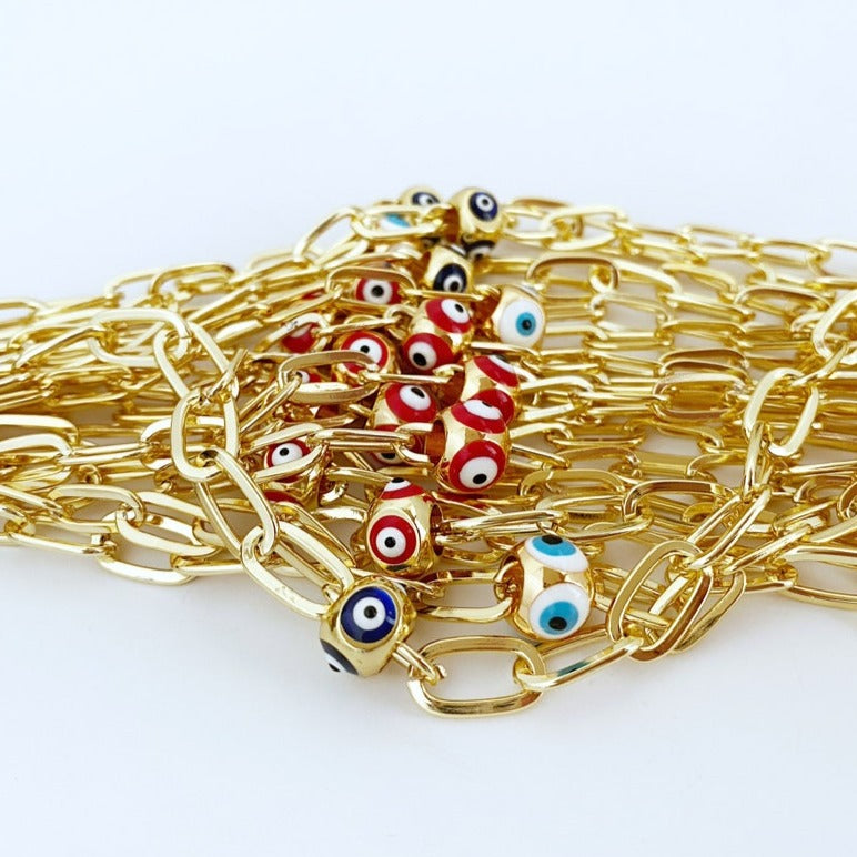 Gold Evil Eye Ankle Bracelet featuring a blue and red charm, perfect for summer jewelry.