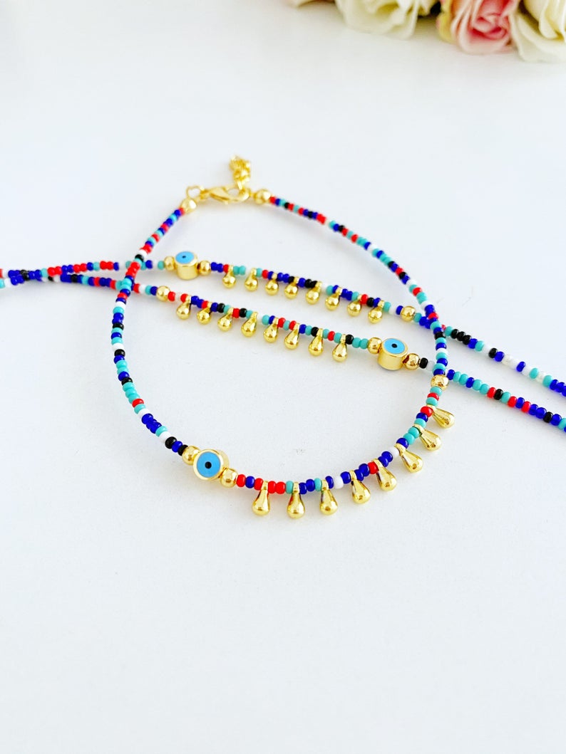 Colorful Evil Eye Anklet made with seed beads, featuring a protective charm, perfect for beach and boho styles.