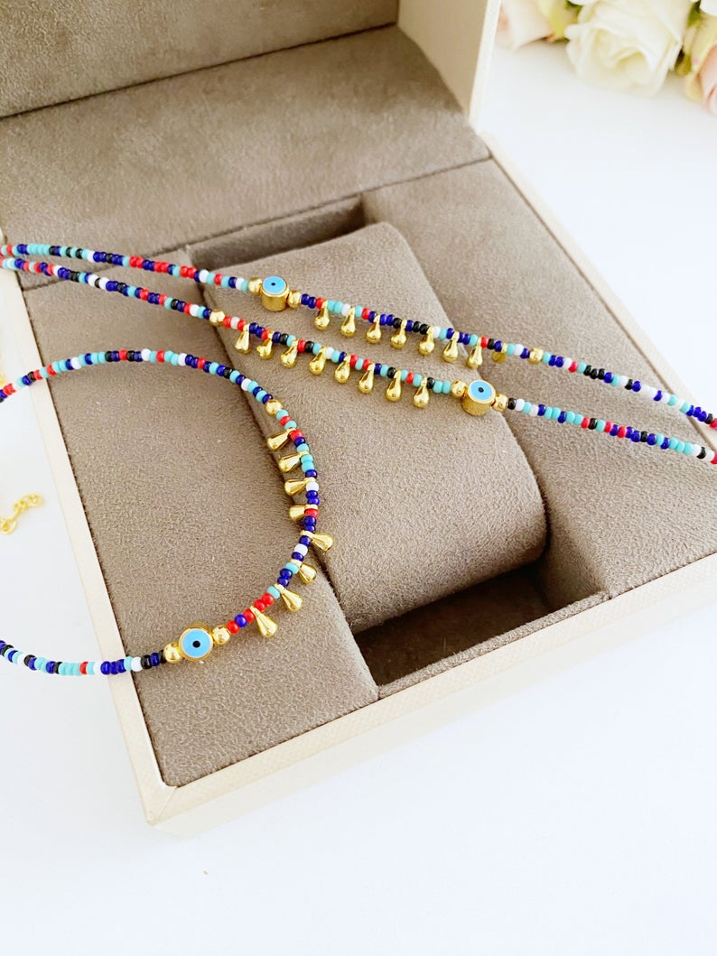 Colorful Evil Eye Anklet made with seed beads, featuring a protective charm, perfect for beach and boho styles.