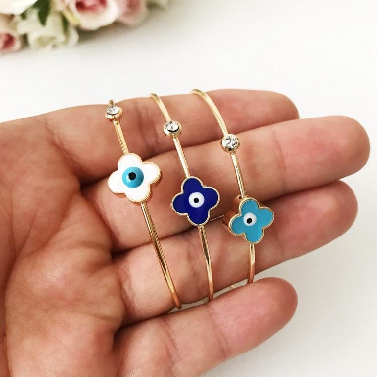 Evil Eye Bangle Bracelet featuring a movable oval charm and clover design in various colors, made from durable stainless steel.