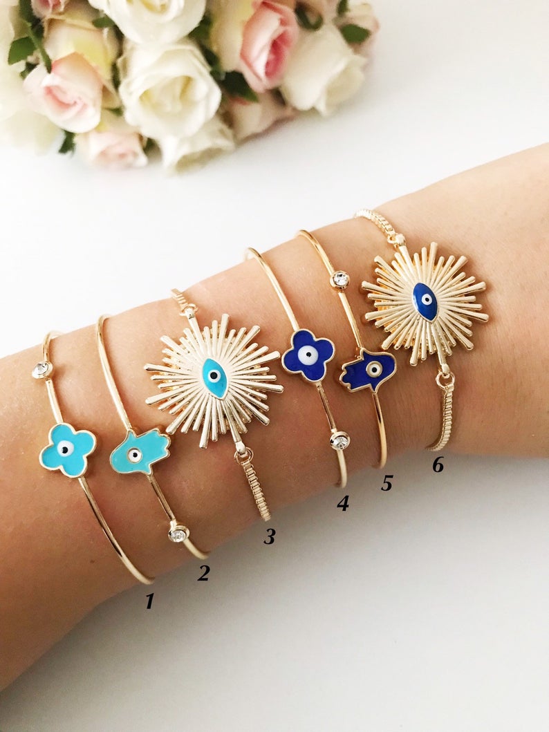 A beautifully crafted Evil Eye Bangle Bracelet featuring a movable oval evil eye charm, made from durable stainless steel.