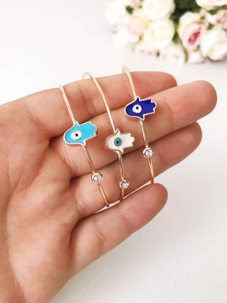 A beautifully crafted Evil Eye Bangle Bracelet featuring a movable oval evil eye charm, made from durable stainless steel.