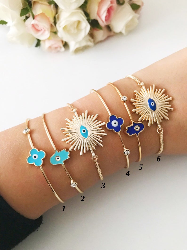A beautifully crafted Evil Eye Bangle Bracelet featuring a movable oval evil eye charm, made from durable stainless steel.