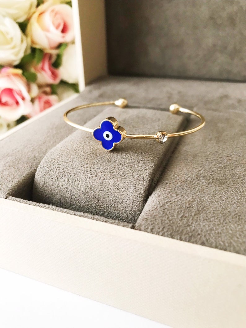 A beautifully crafted Evil Eye Bangle Bracelet featuring a movable oval evil eye charm, made from durable stainless steel.