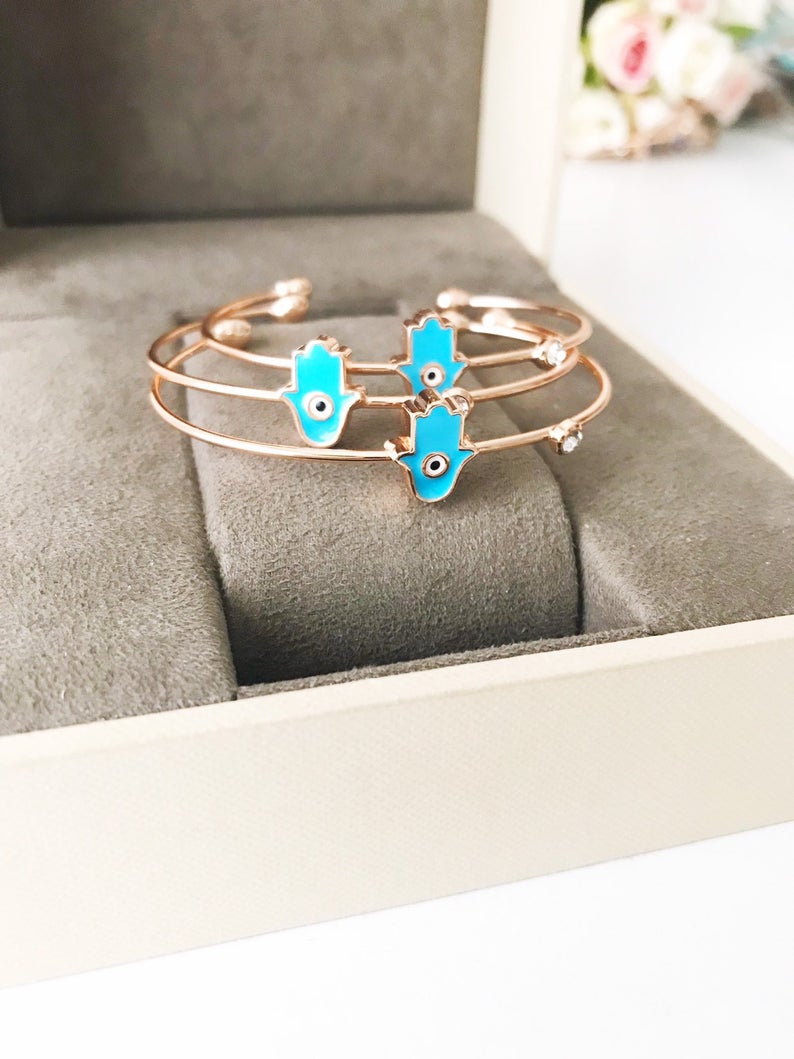 A beautifully crafted Evil Eye Bangle Bracelet featuring a movable oval evil eye charm, made from durable stainless steel.