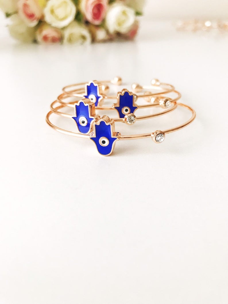 A beautifully crafted Evil Eye Bangle Bracelet featuring a movable oval evil eye charm, made from durable stainless steel.