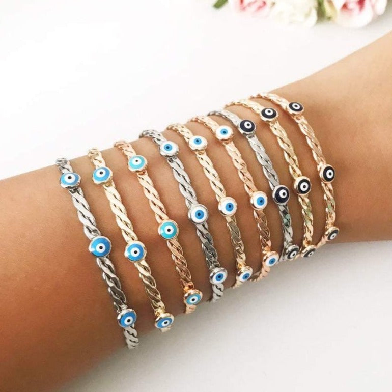Evil Eye Bangle Bracelet featuring a movable oval charm, available in rose gold and silver finishes with customizable bead colors.