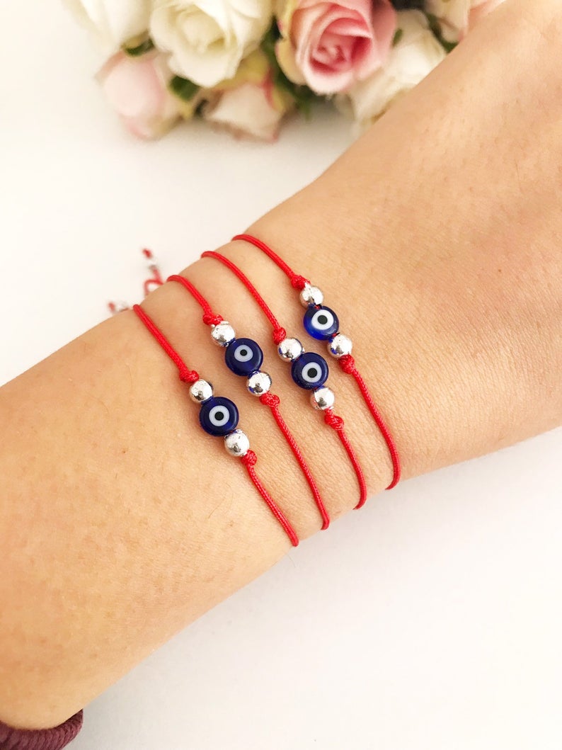 Handmade Evil Eye Bead Bracelet featuring a blue evil eye bead on an adjustable red macramé string.