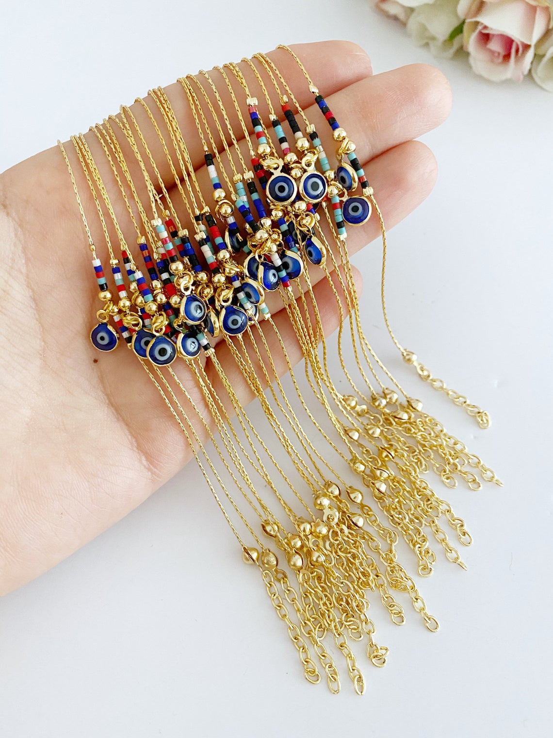 Handmade Evil Eye Bead Bracelet featuring blue, red, and white Miyuki seed beads with an adjustable size and evil eye charm.