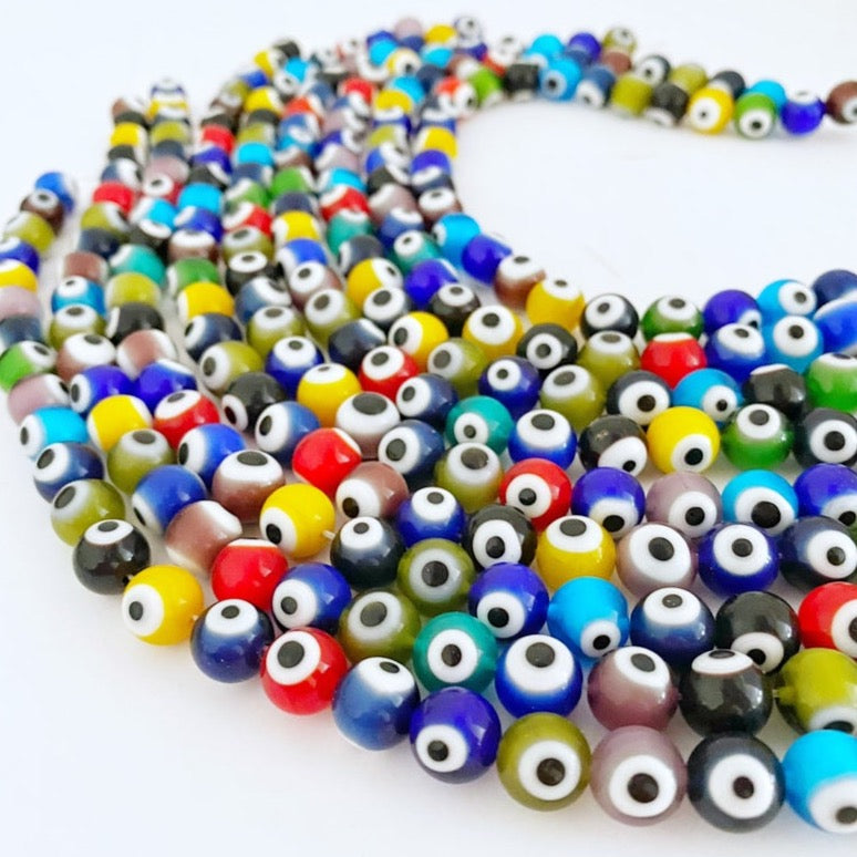 A strand of 10 mm round multicolor evil eye beads, showcasing vibrant colors and intricate designs, perfect for jewelry making.