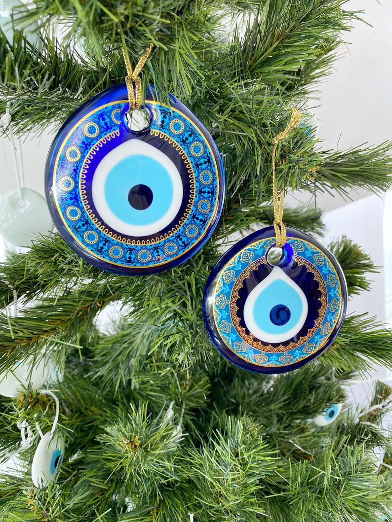 A collection of blue glass evil eye beads, featuring intricate patterns, perfect for Christmas tree decoration and wall hanging.