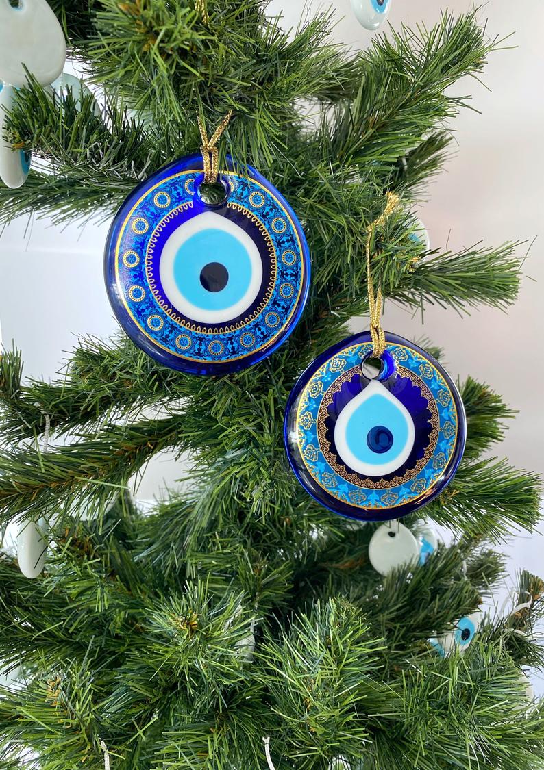 A collection of blue glass evil eye beads, featuring intricate patterns, perfect for Christmas tree decoration and wall hanging.