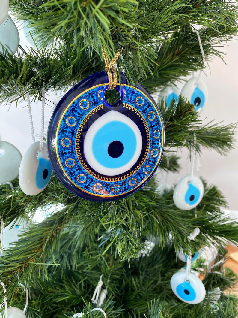 A collection of blue glass evil eye beads, featuring intricate patterns, perfect for Christmas tree decoration and wall hanging.