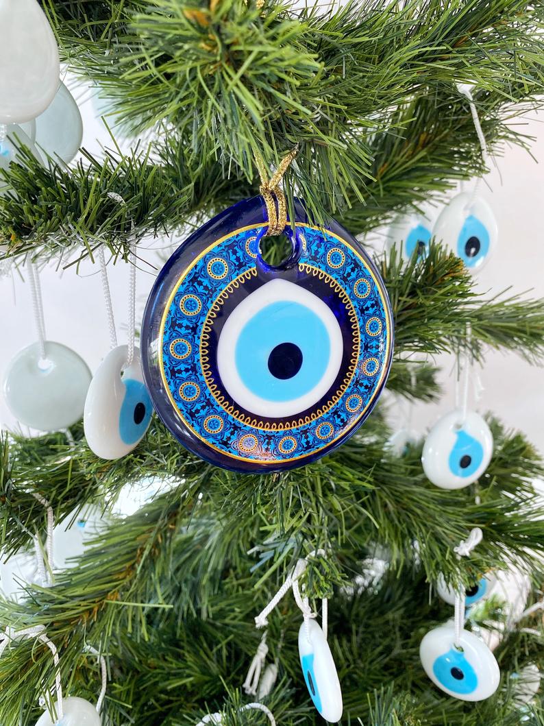 A collection of blue glass evil eye beads, featuring intricate patterns, perfect for Christmas tree decoration and wall hanging.