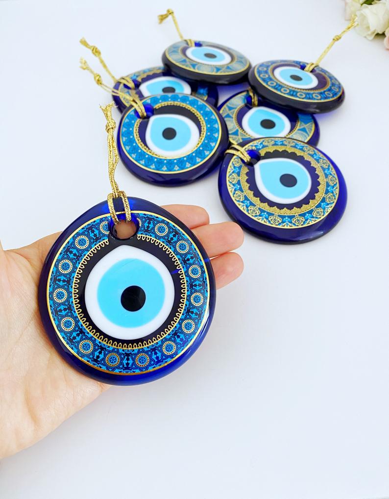 A collection of blue glass evil eye beads, featuring intricate patterns, perfect for Christmas tree decoration and wall hanging.