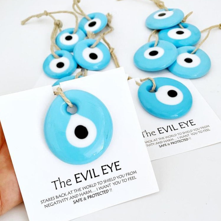 Handmade blue glass evil eye beads with personalized card, perfect for wedding favors.