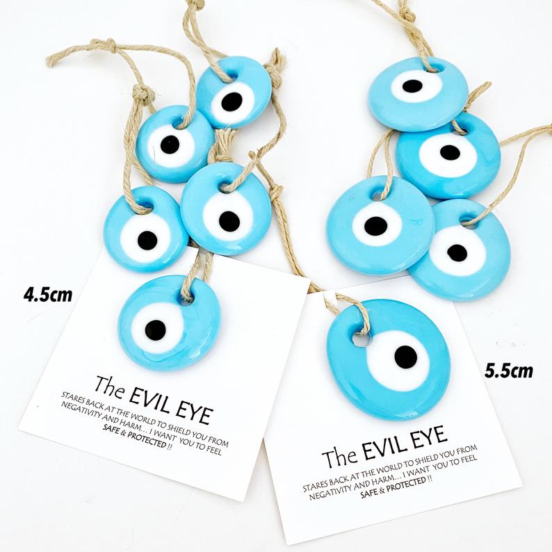 Handmade blue glass evil eye beads with personalized card, perfect for wedding favors.