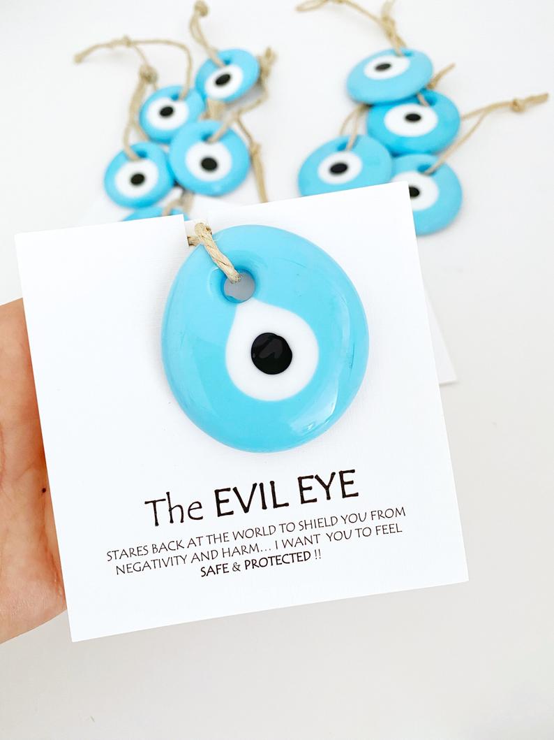 Handmade blue glass evil eye beads with personalized card, perfect for wedding favors.