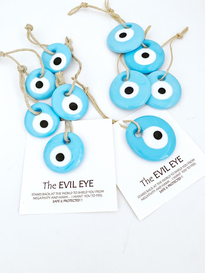 Handmade blue glass evil eye beads with personalized card, perfect for wedding favors.