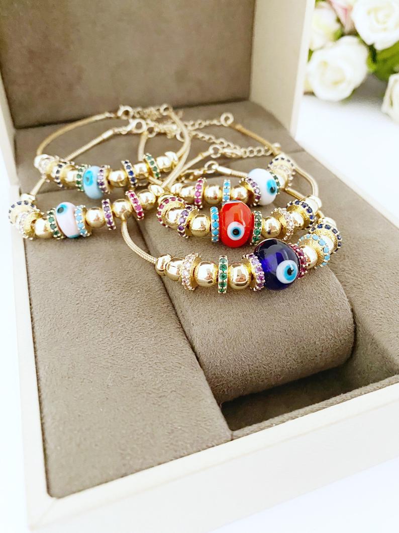 A beautiful Evil Eye Bracelet featuring a colorful glass charm and adjustable stainless steel design, perfect for everyday wear and protection.